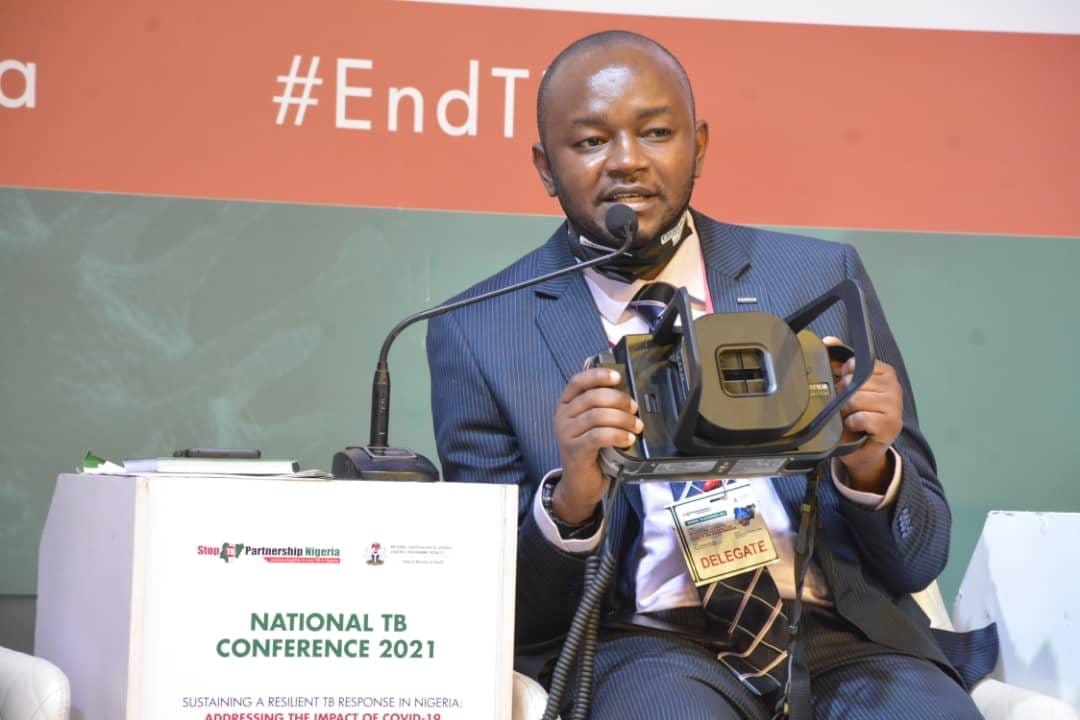 Godspower Asika presenting an ultra-portable, battery-powered X-ray system at the National TB Conference 2021 in Nigeria